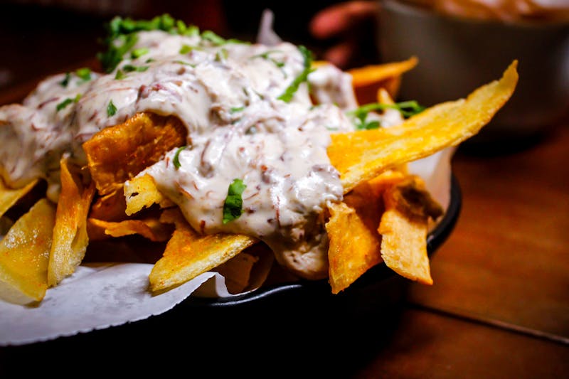 Loaded fries with cheese and toppings at Via 313